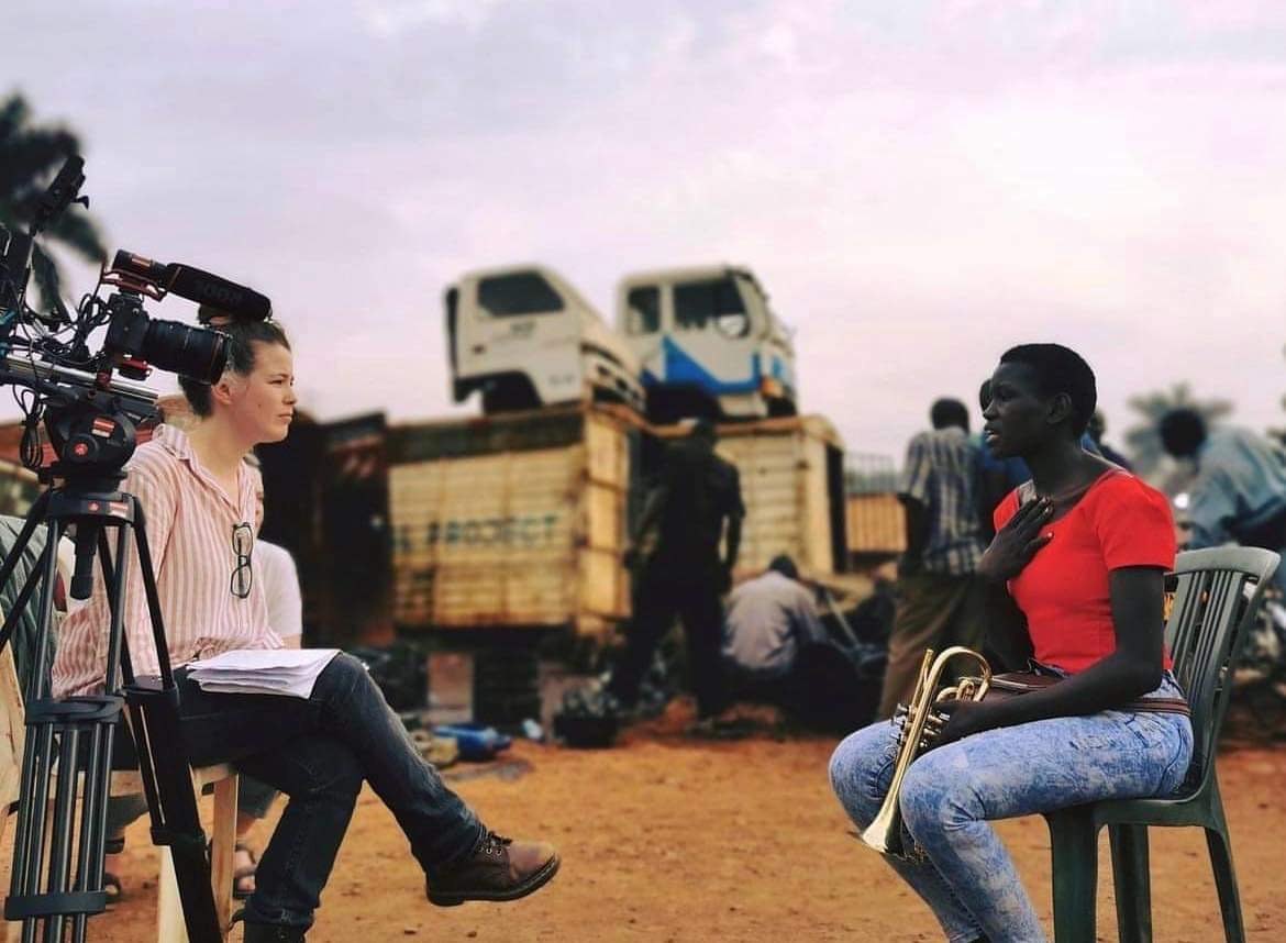 Andrea filming an interview with a young trumpet player