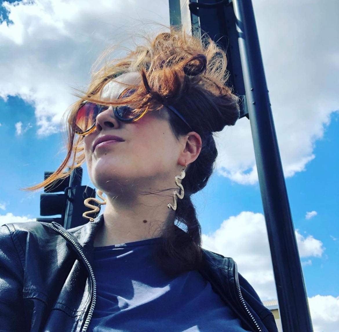 Andrea in sunglasses against a blue sky