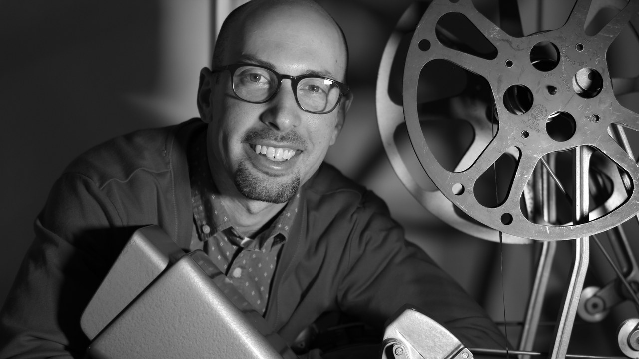 Jacob A. Dodd beside a 16mm projector