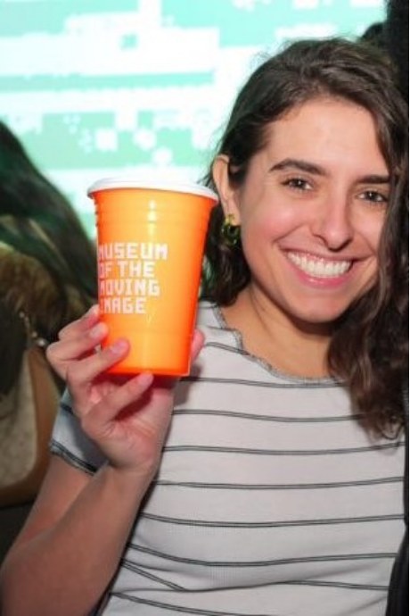Nicole Matarese holding a Museum of the Moving Image cup